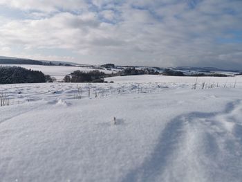 Scenic view of snow covered landscape against sky