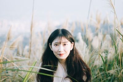 Portrait of young woman in field