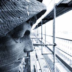 Close-up of statue against railing