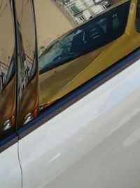 Close-up of yellow car on window