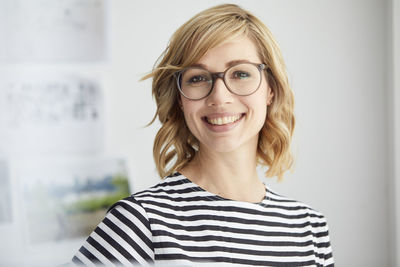 Portrait of smiling blond woman, glasses