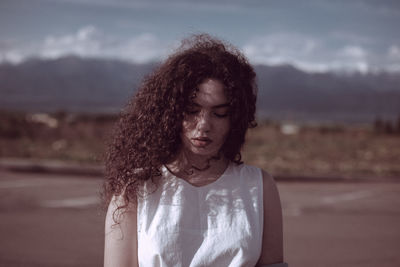 Thoughtful woman standing on land