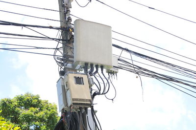 Low angle view of electricity pylon against sky