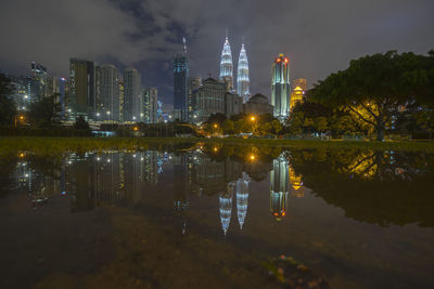 Reflection of illuminated buildings in lake at night