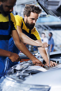 Side view of man using mobile phone