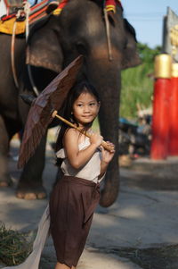 Portrait of young woman standing outdoors