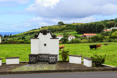 Built structure on field against sky