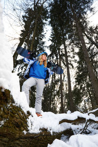 Low angle view of woman on snow covered land