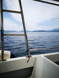 Sailboat sailing on sea against sky seen through window