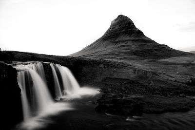 Scenic view of waterfall against sky