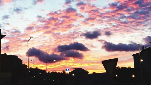 Silhouette of building against dramatic sky