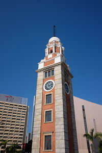 Low angle view of clock tower against clear sky