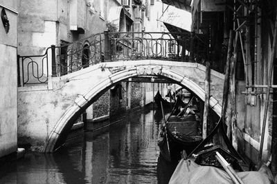 Bridge over canal amidst buildings in city