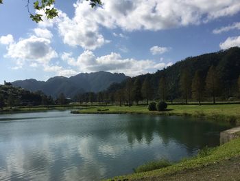 Scenic view of lake and mountains against sky