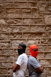 Rear view of man standing against wall