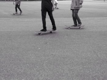 Low section of man walking on road