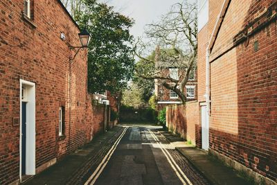 Empty alley amidst buildings in city