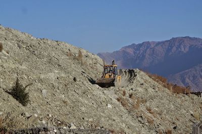 Lifeguard hut on mountain against sky