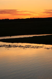 Scenic view of land against sky during sunset