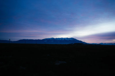 Scenic view of silhouette mountains against sky at sunset