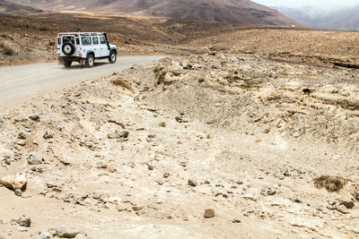 Car on dirt road in desert