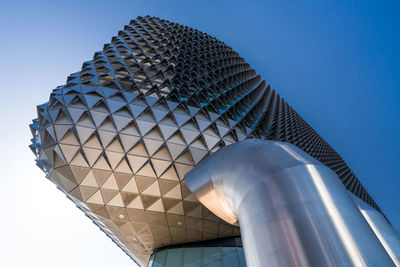 Low angle view of modern building against clear blue sky