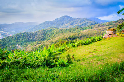 Scenic view of mountains against cloudy sky