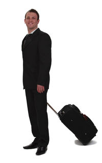 Portrait of young man standing against white background