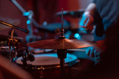 Midsection of person playing drums at music concert