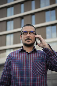 Portrait of young man standing outdoors