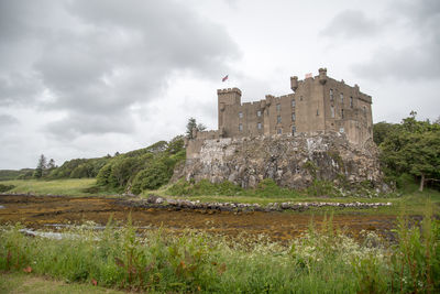 Built structure on beach against sky