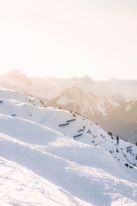 Scenic view of snow covered mountains against sky