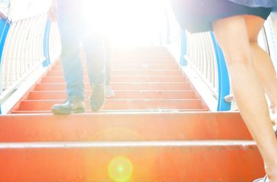 Low section of woman walking on staircase