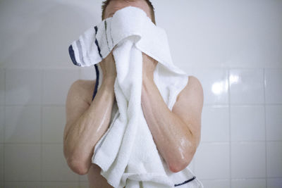 Midsection of man standing in bathroom