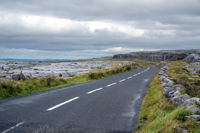 Empty road along countryside landscape