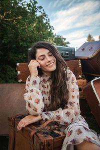 Smiling young woman sitting outdoors