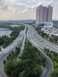 High angle view of street amidst buildings against sky