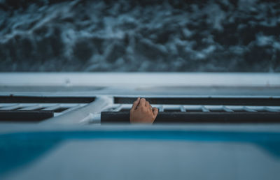 Cropped image of hand on window