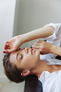 Midsection of doctor examining patient at home