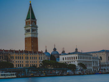 View of buildings in city against clear sky