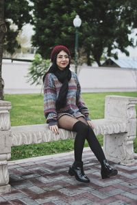 Portrait of smiling young woman sitting outdoors