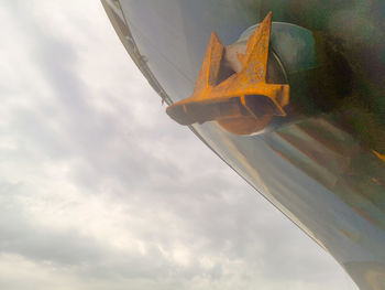 Low angle view of airplane flying against sky