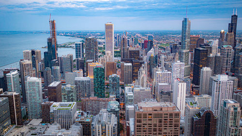 Aerial view of modern buildings in city against sky