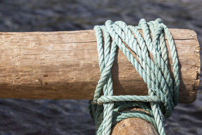 Close-up of rope tied on wood