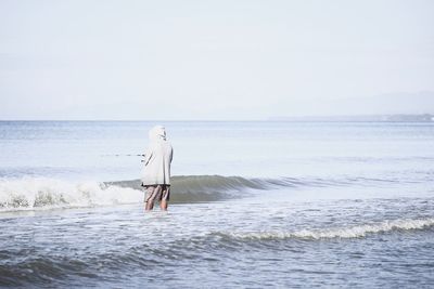 Rear view of person standing on beach