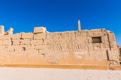 Low angle view of historical building against blue sky