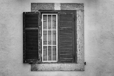 Close-up of abandoned window of building