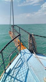 Fishing net in sea against sky