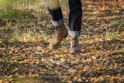 Low section of man standing on field