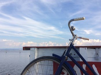 Ferris wheel by sea against sky